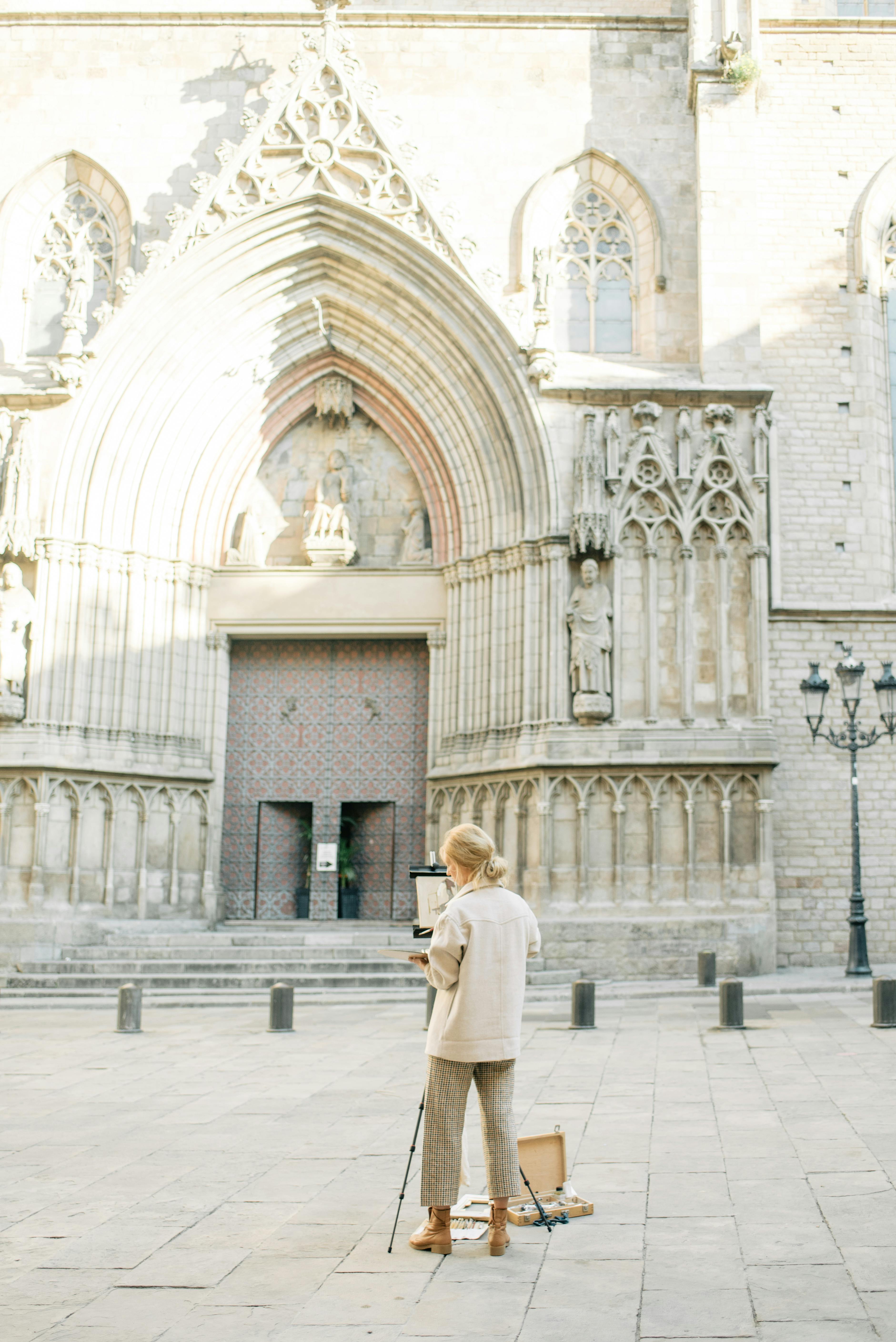 blonde woman painting santa maria del mar church in barcelona spain