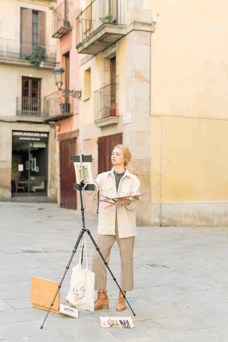 A Woman Painting On The Street