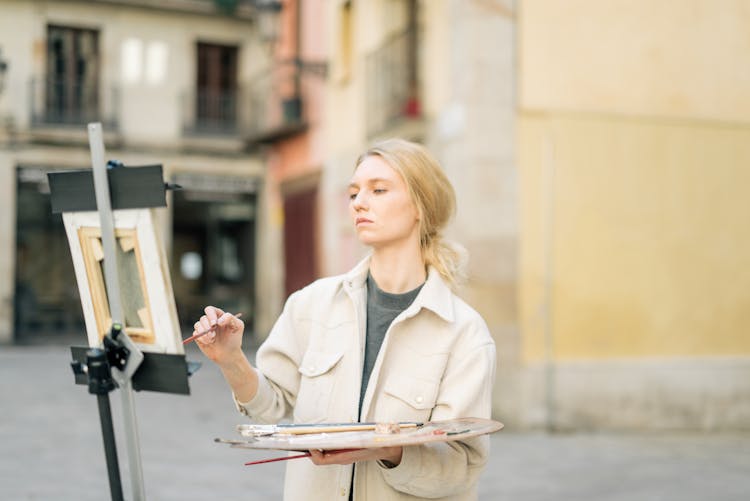 A Woman Painting On The Street