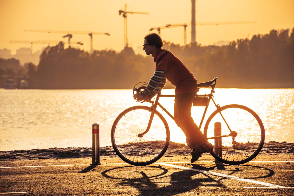 Person wearing headphones and speaking into a microphone in front of a laptop