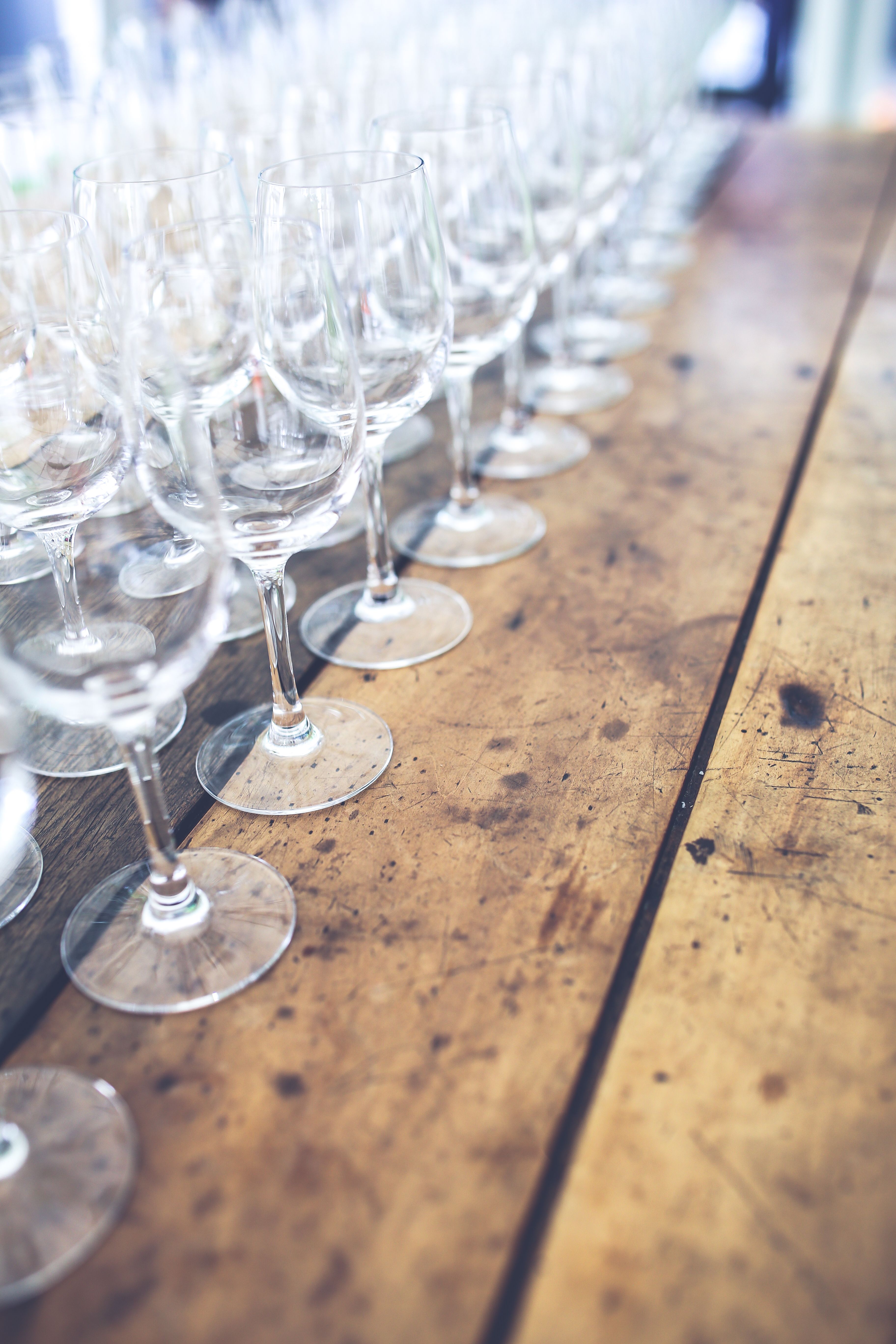 Wine glasses filled at different levels on a table