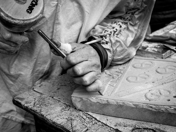 Black And White Archival Photo Of A Man Carving