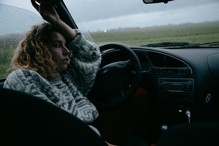 Sad Woman Sitting In Car