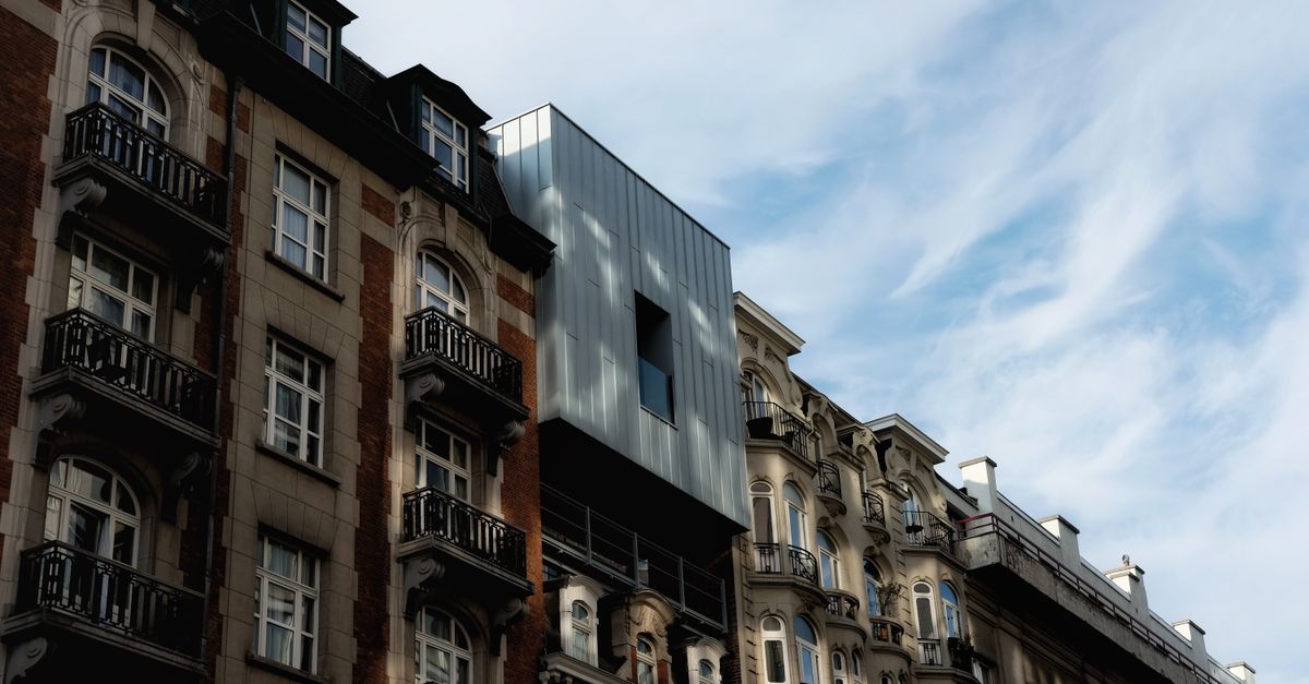View of Brussels architecture blending classic buildings with modern design under a clear sky.