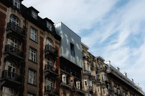 Free View of Brussels architecture blending classic buildings with modern design under a clear sky. Stock Photo