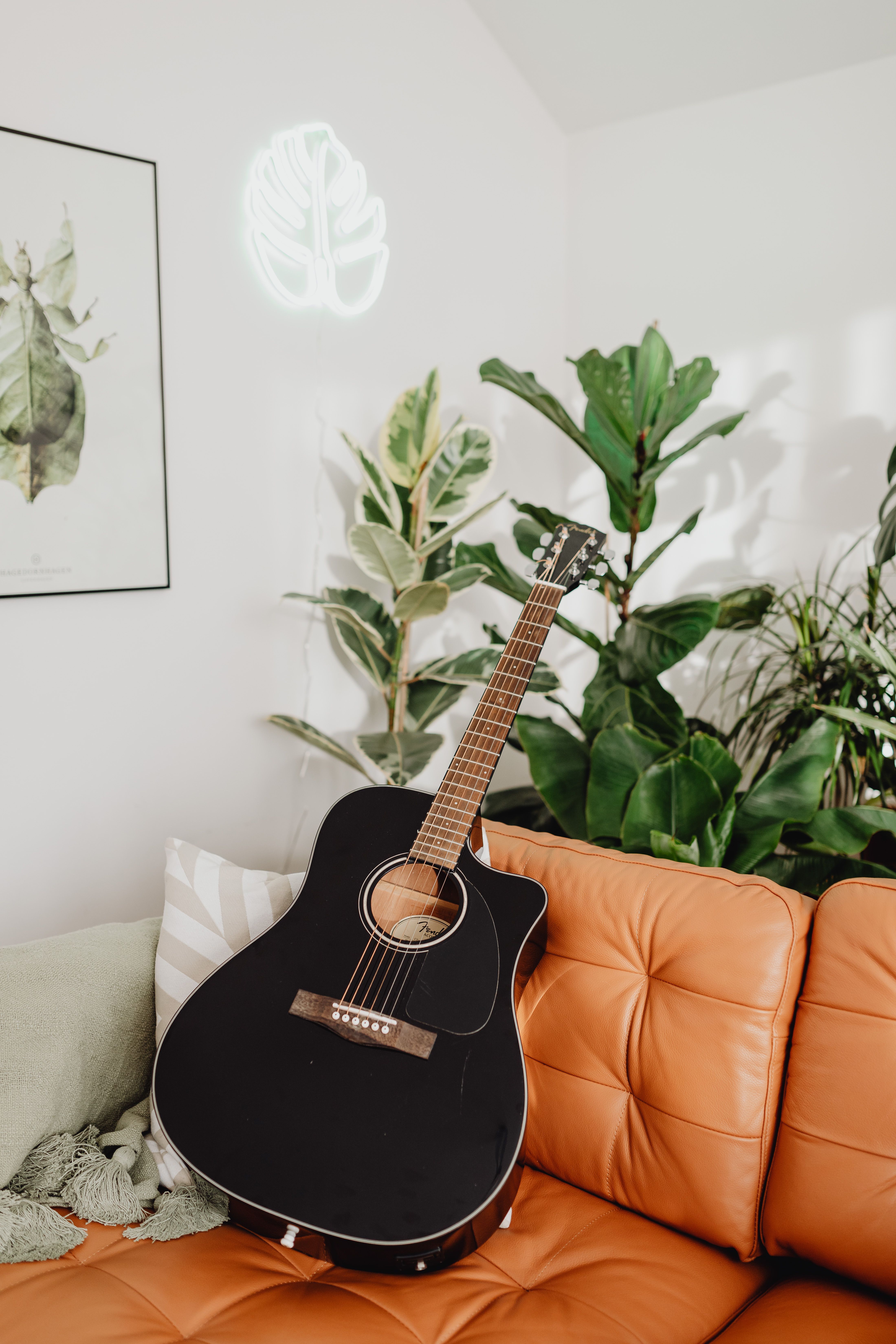 Acoustic Guitar on an Orange Couch