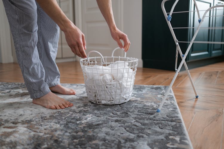 Man With Laundry Basket In Apartment