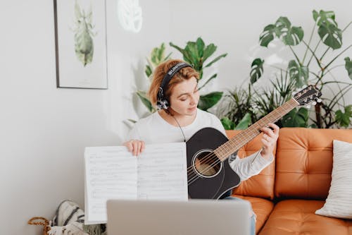 Happy Woman Playing Guitar Having Online Class