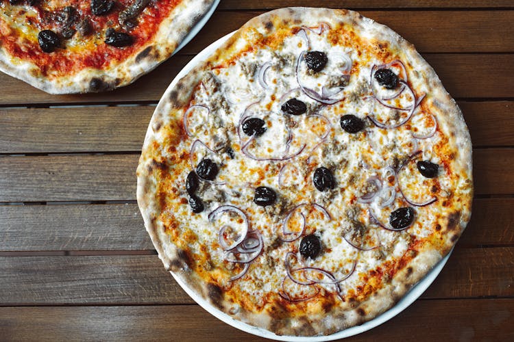 A Whole Pizza On A Wooden Table