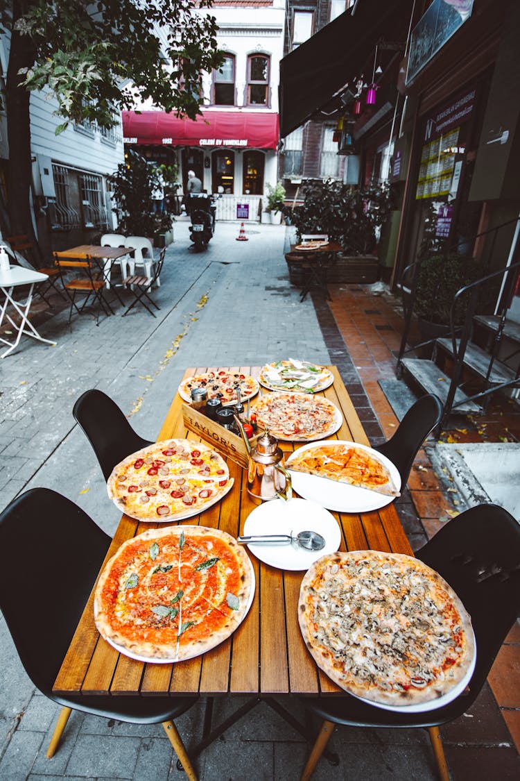 Pizzas On A Table At A Restaurant