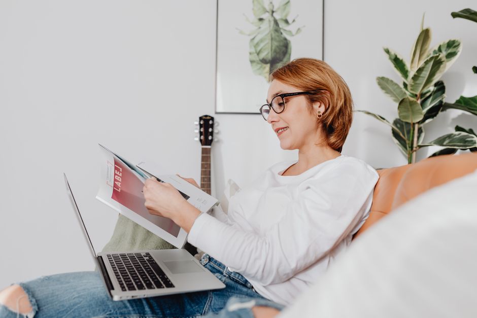 woman reading course brochure laptop