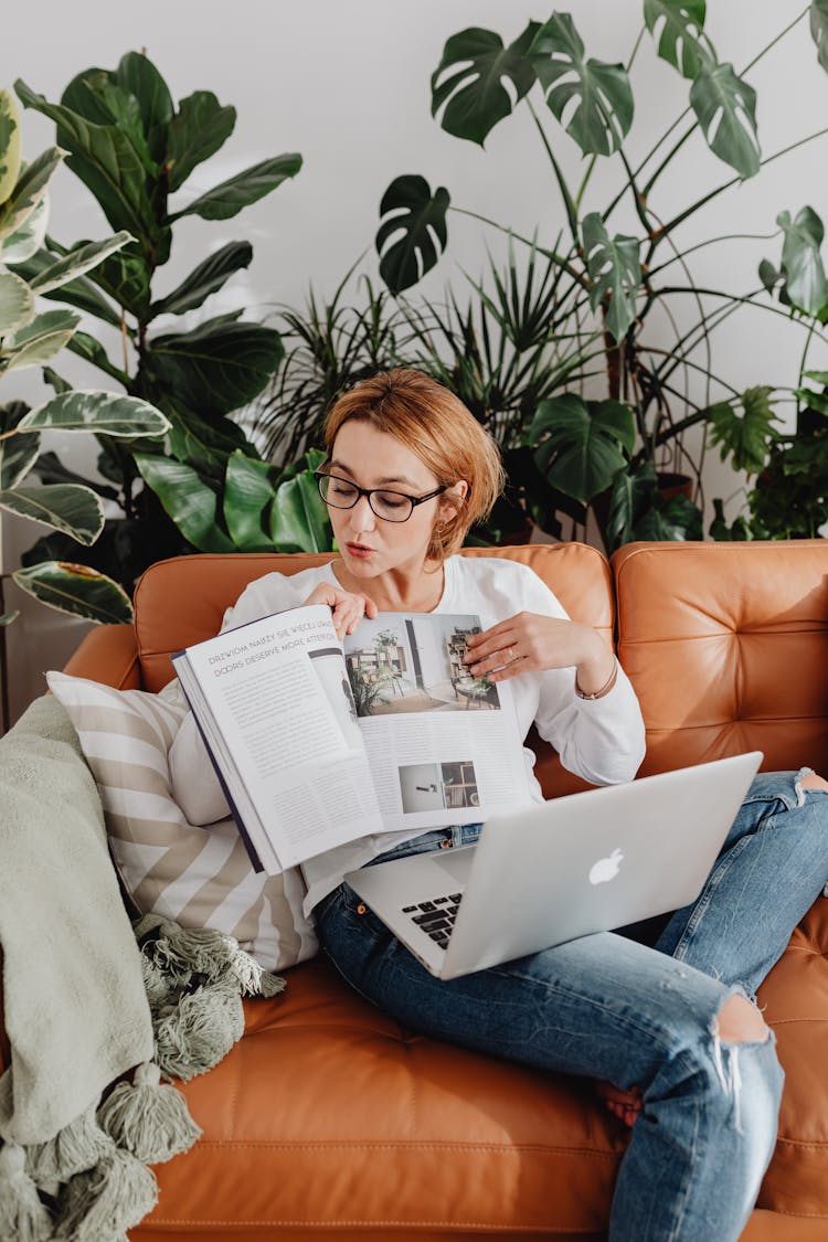 Woman On Video Call Showing Magazine Pages