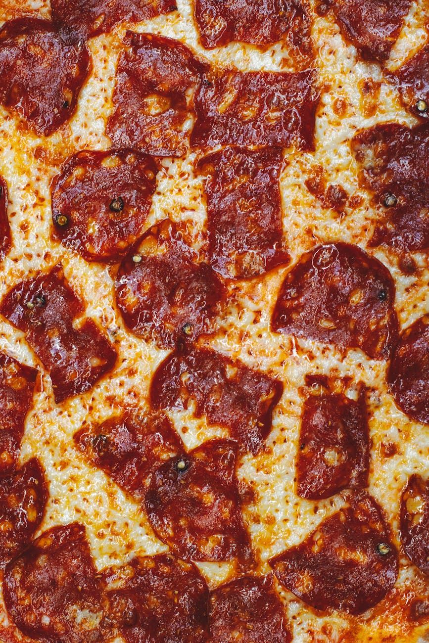 A mouth-watering close-up of pepperoni pizza with melted cheese.