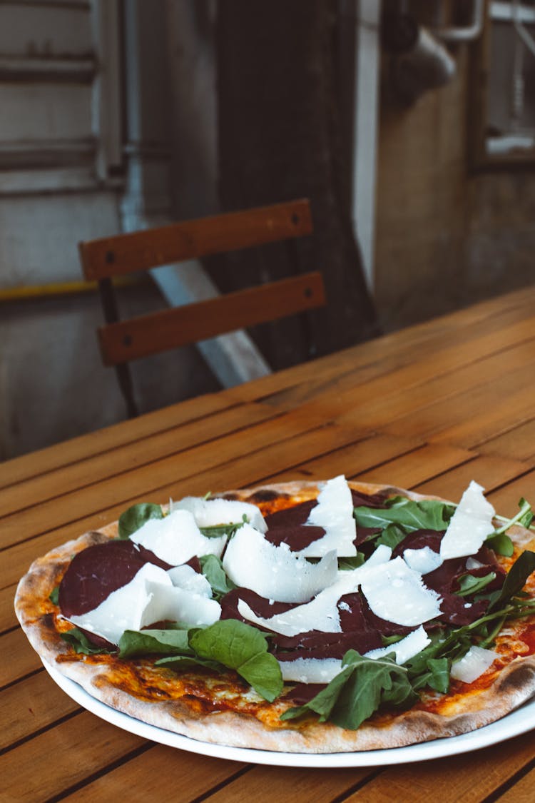 Pizza With Vegetables Toppings On A Wooden Table