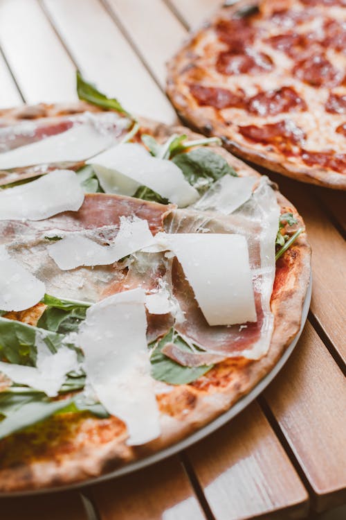 Plates of Pizzas on a Wooden Surface