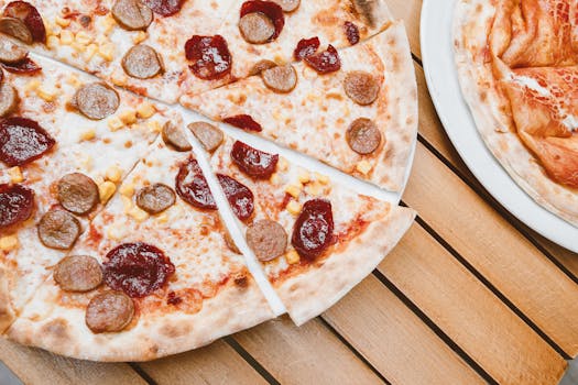 Delicious pepperoni and sausage pizza slices on a rustic wooden table.