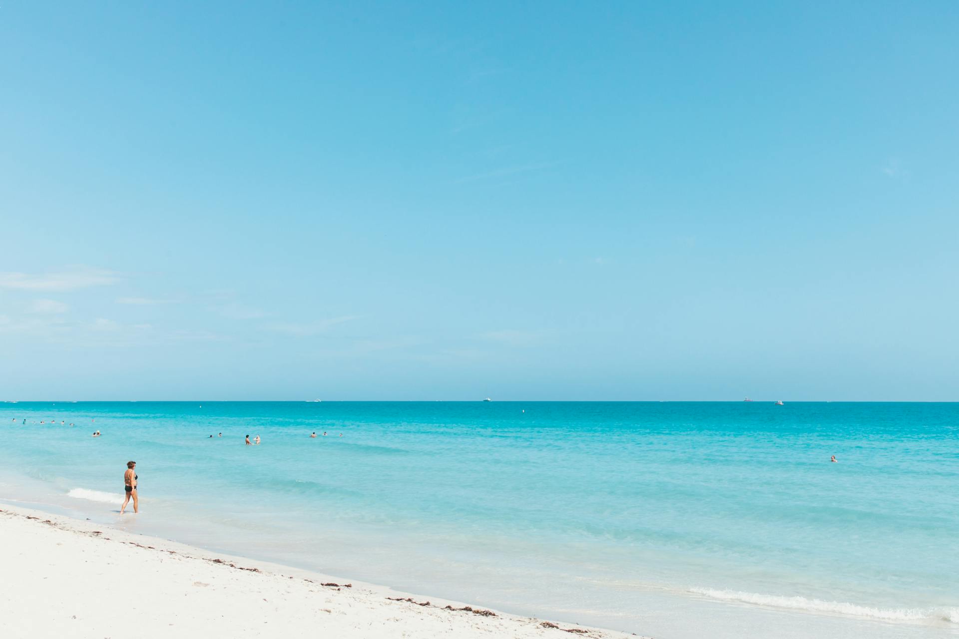 Beautiful sunny day at Miami Beach featuring clear blue skies and turquoise waters.