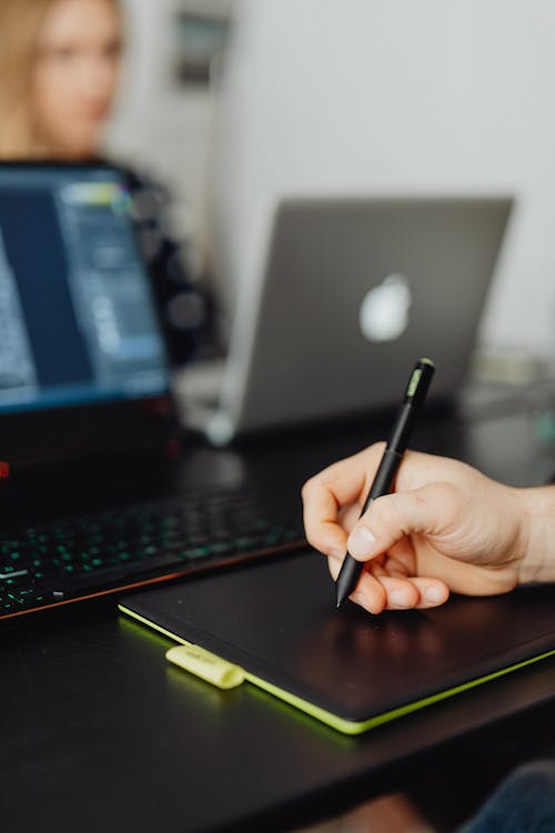 Close up on Hand Writing on Tablet in an Office