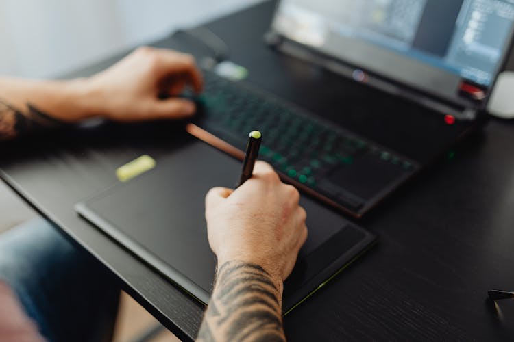 Person Holding Black Stylus Pen