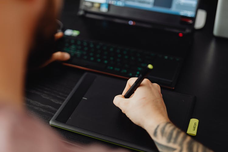 Person Holding Black Stylus Pen