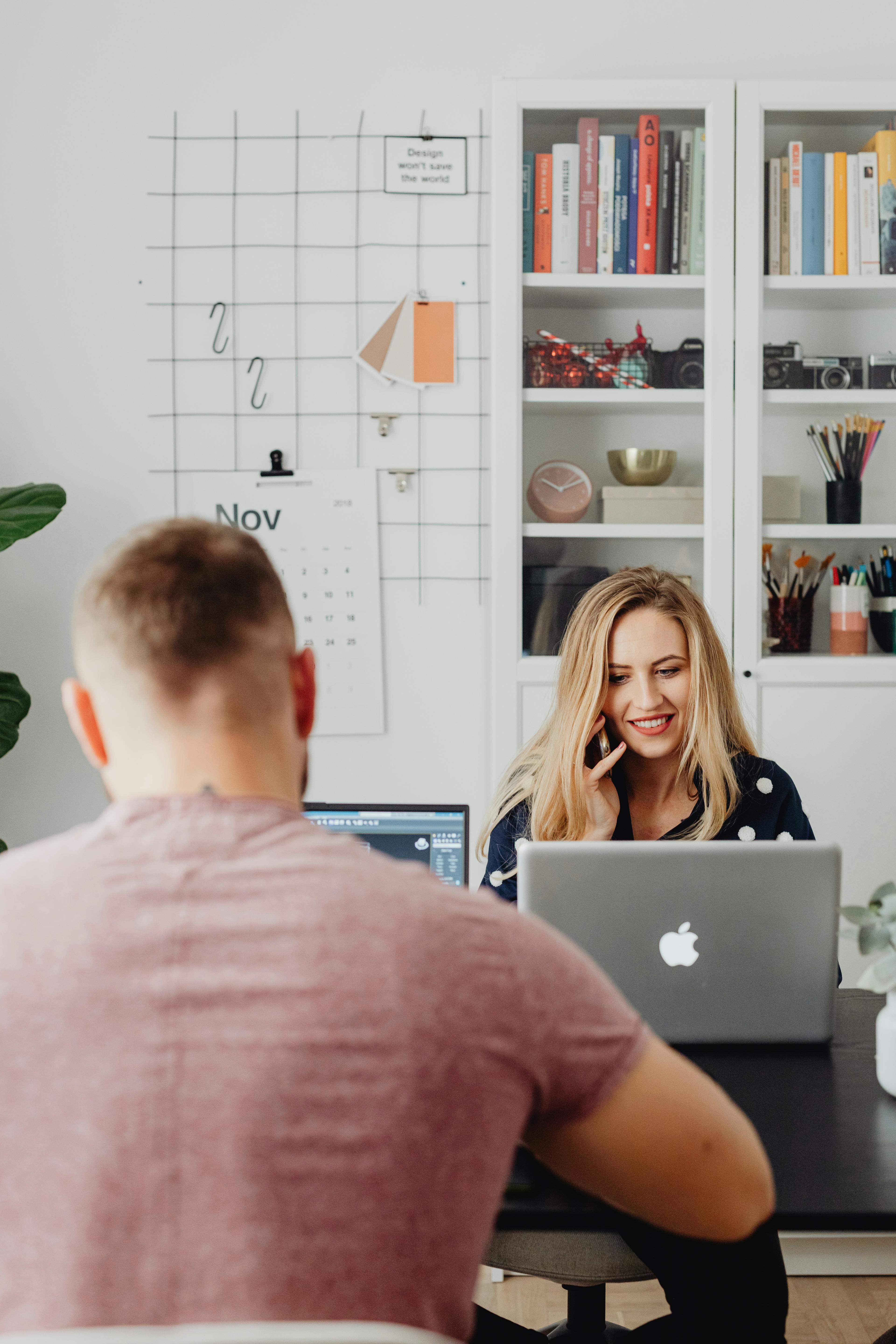 A creative team collaborating on a visual content calendar in a bright modern office space.
