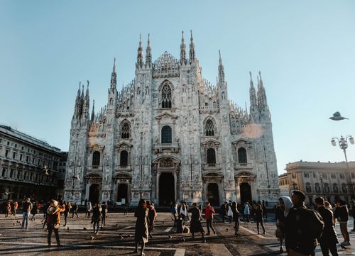 Free Capture of the iconic Duomo di Milano with bustling tourists under clear skies. Stock Photo