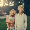 Boy Standing Beside Girl Outdoors