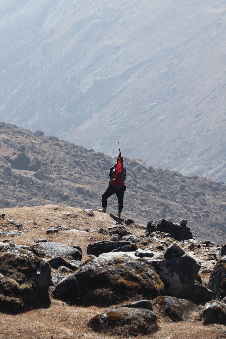 Man Standing On Rock On Mountain Peak