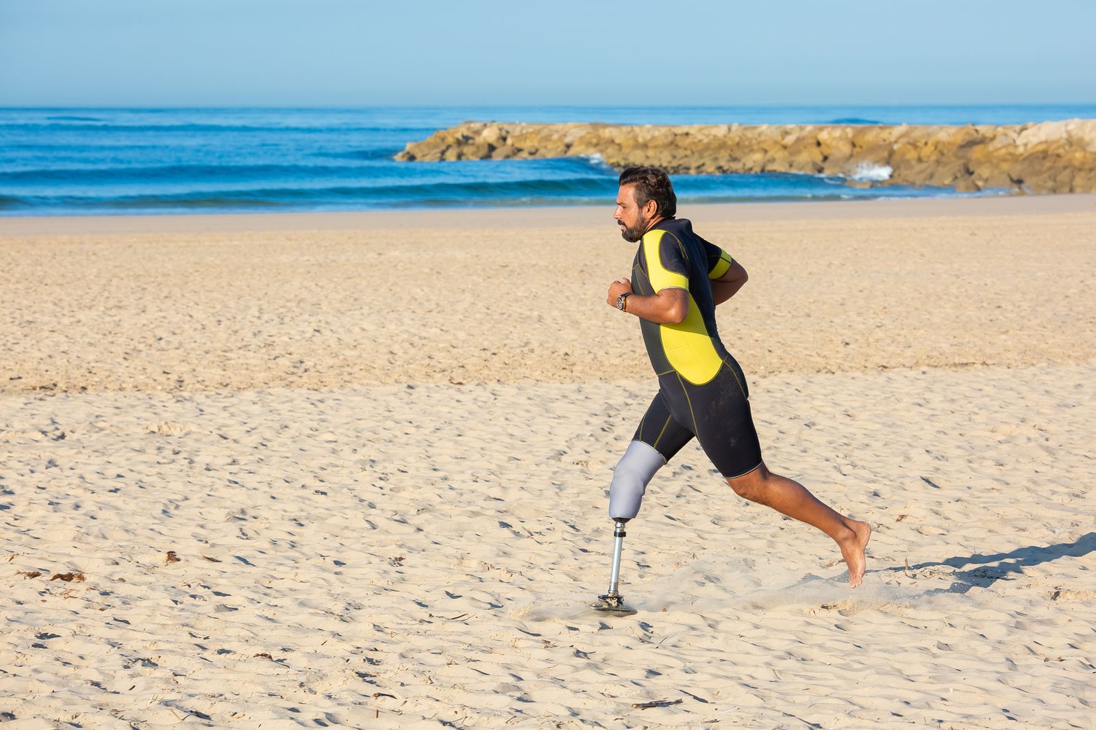 Person outdoors adjusting a knee brace before walking on a bright day