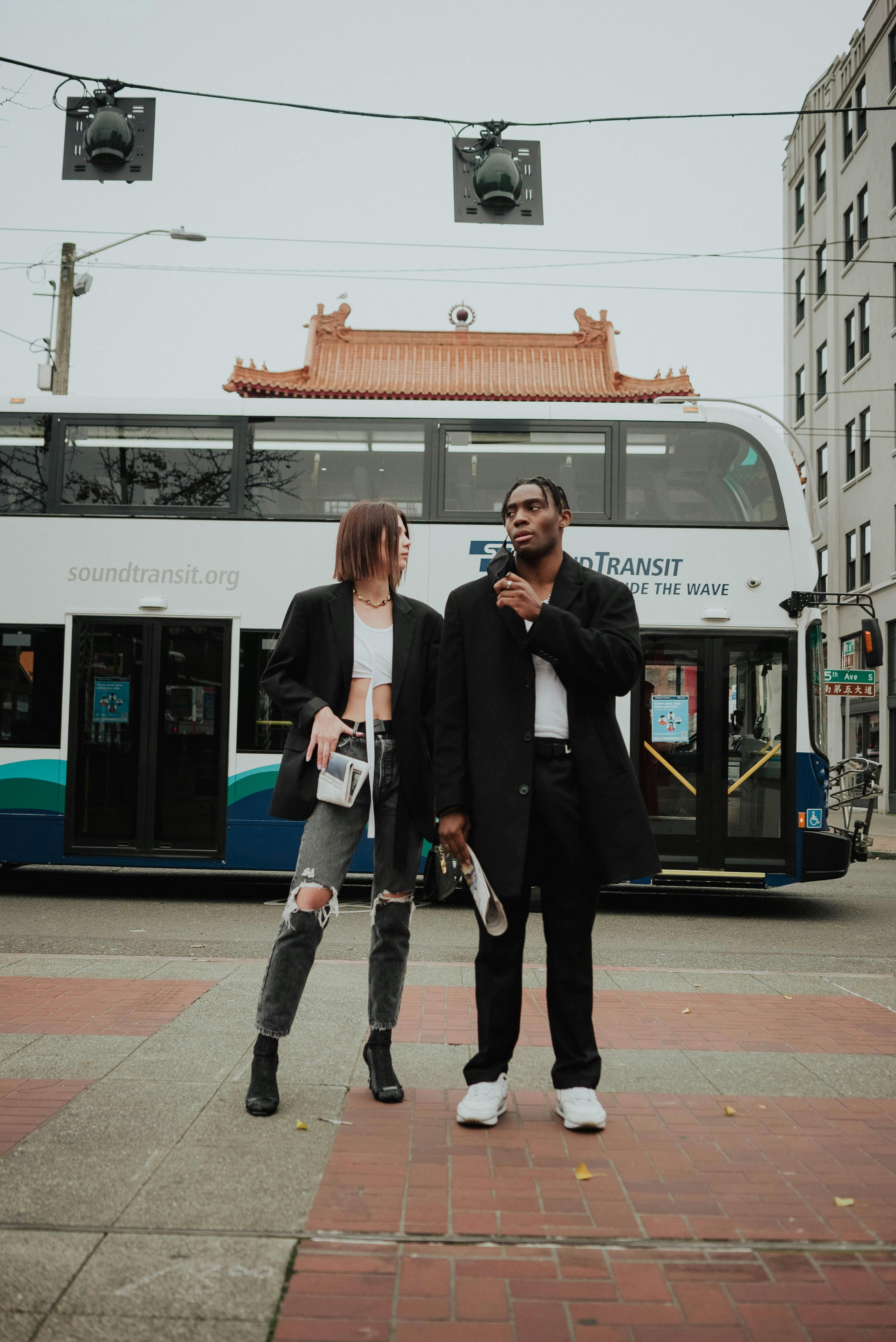 trendy young diverse couple standing on city street