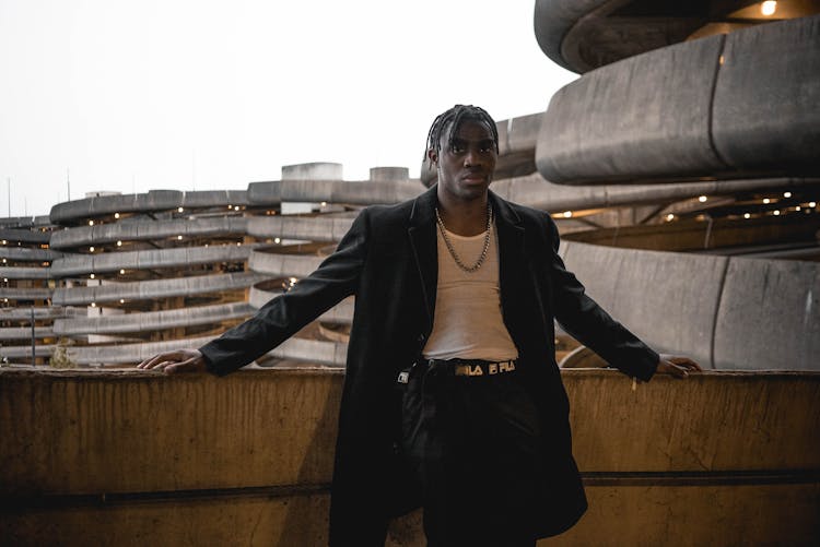 Black Stylish Man Standing On Concrete Balcony