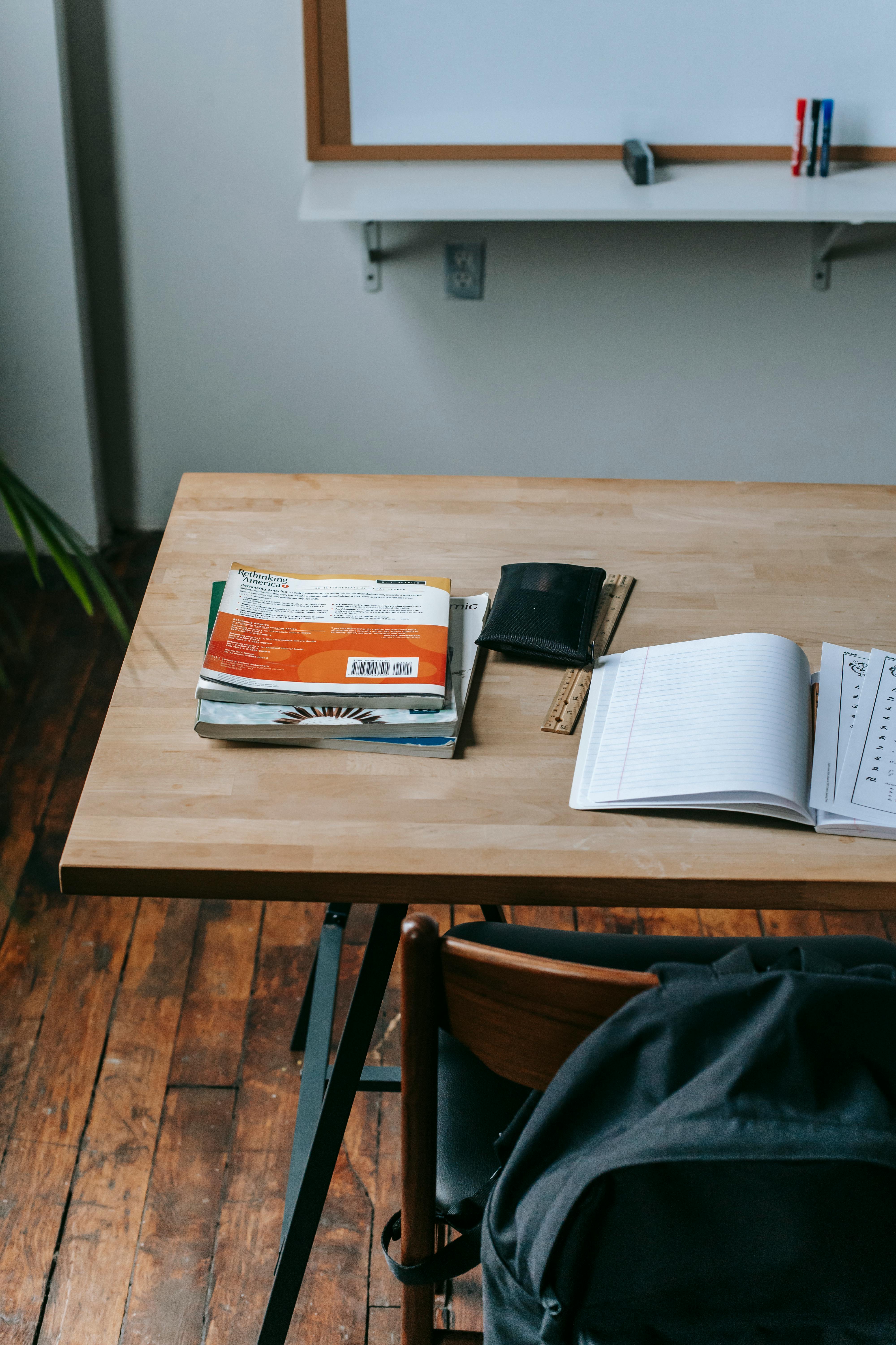 school desk with copybooks in modern classroom