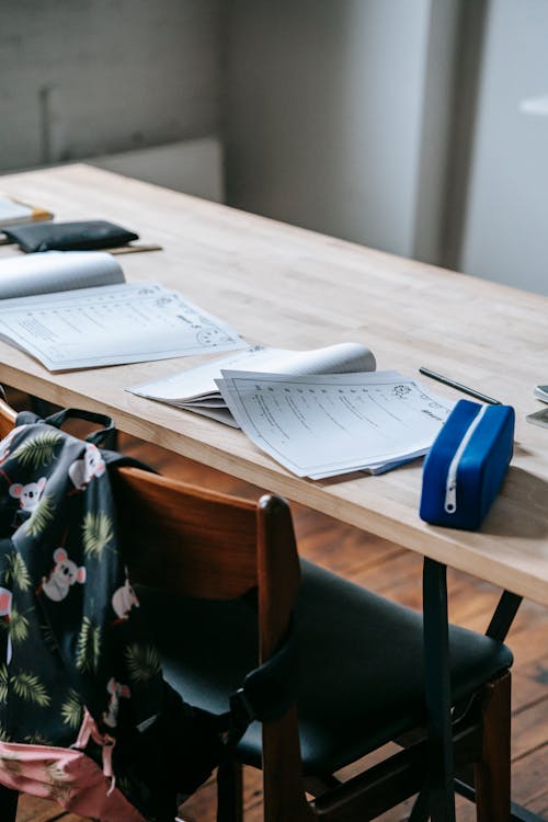 Desk with papers and textbooks in classroom