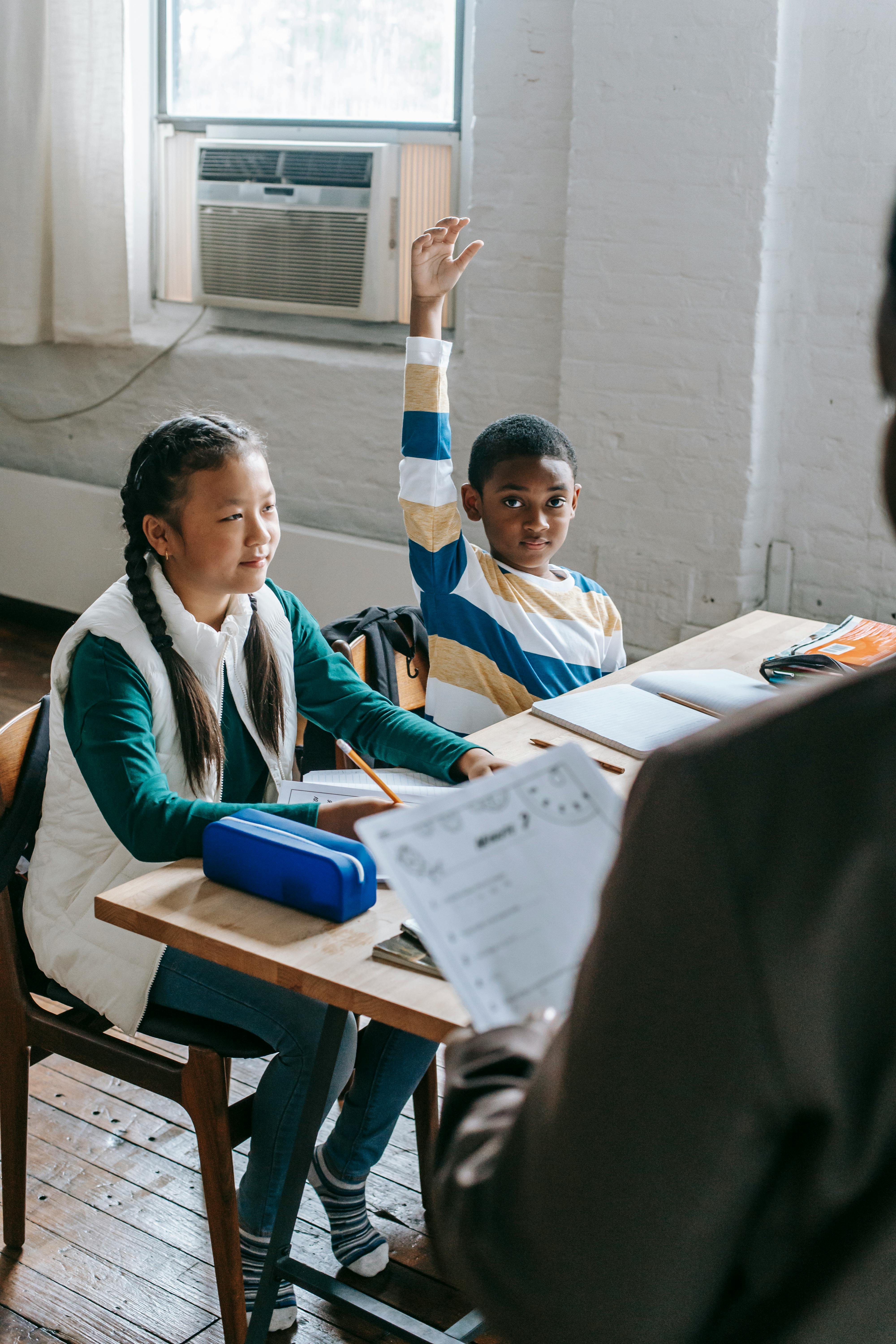 content black man raising hand during lecture in classroom