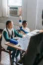 Content black man raising hand during lecture in classroom