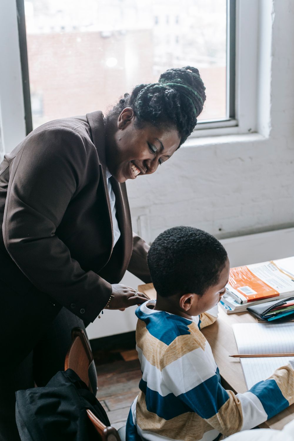 A tutor helping a young pupil with schoolwork
