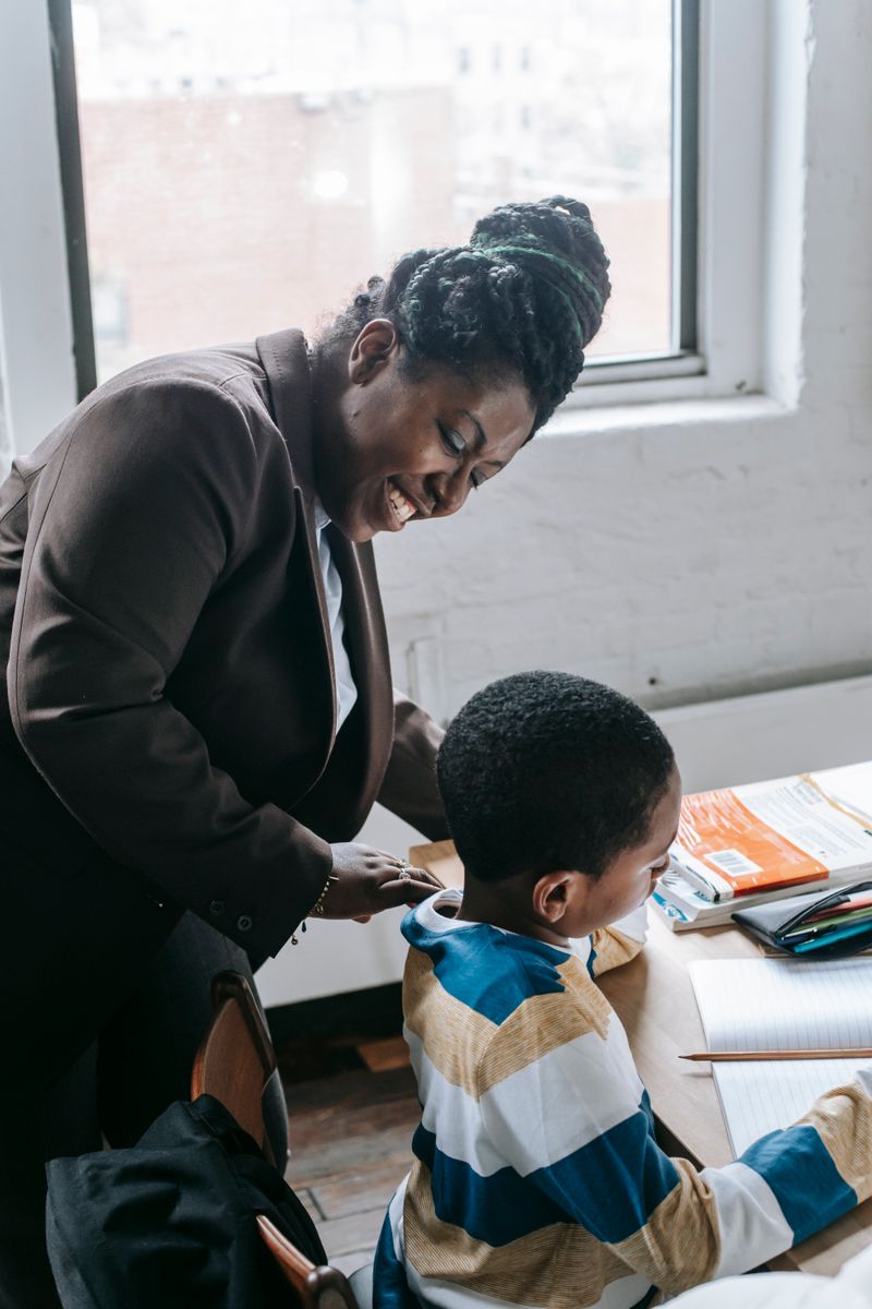 Teacher helping a young pupil with schoolwork