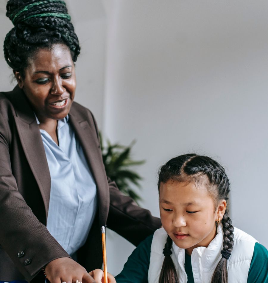 Educational professional guiding a child through a learning exercise