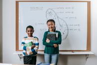 Smart little multiracial schoolchildren doing presentation during biology class
