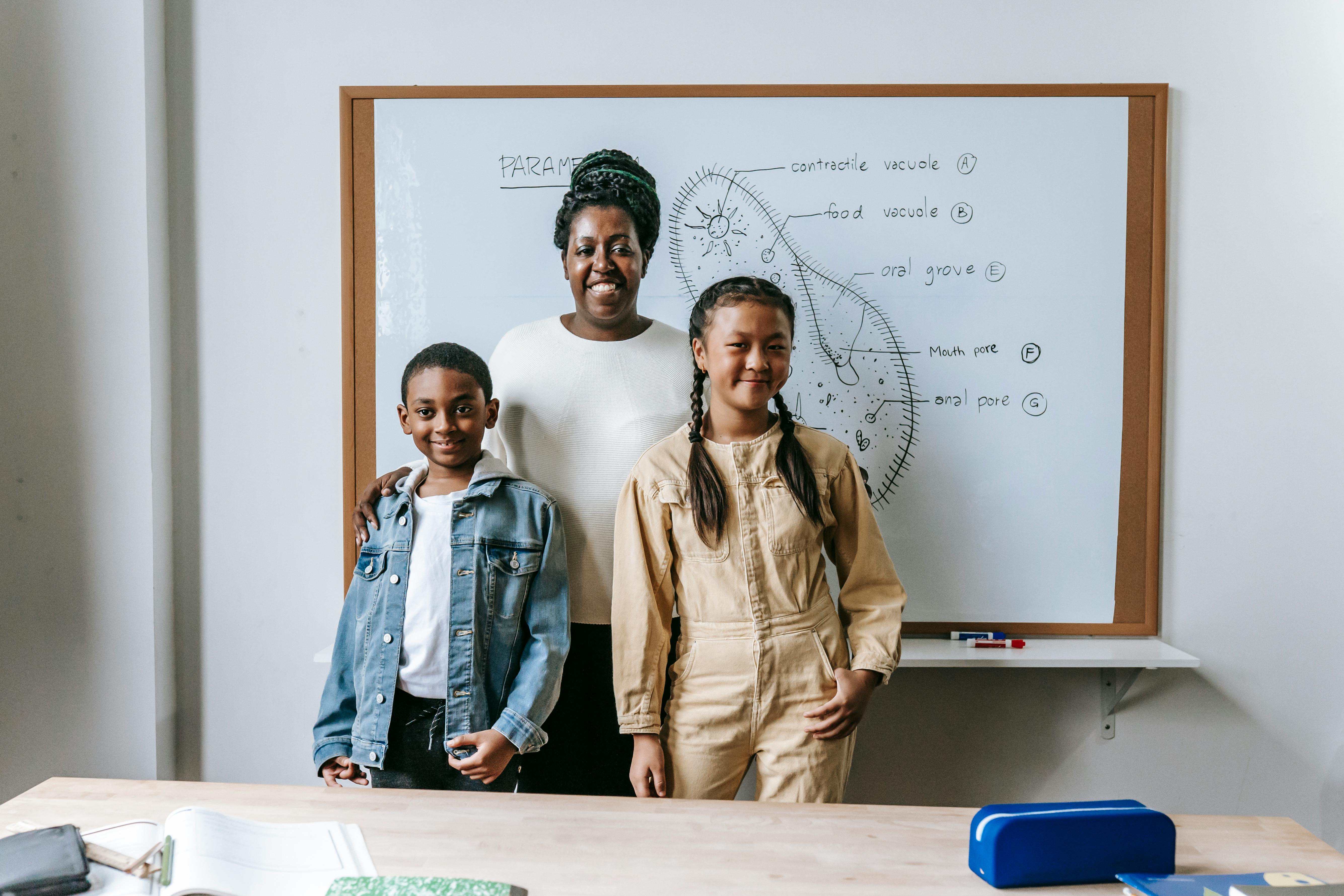 cheerful teacher with students in classroom