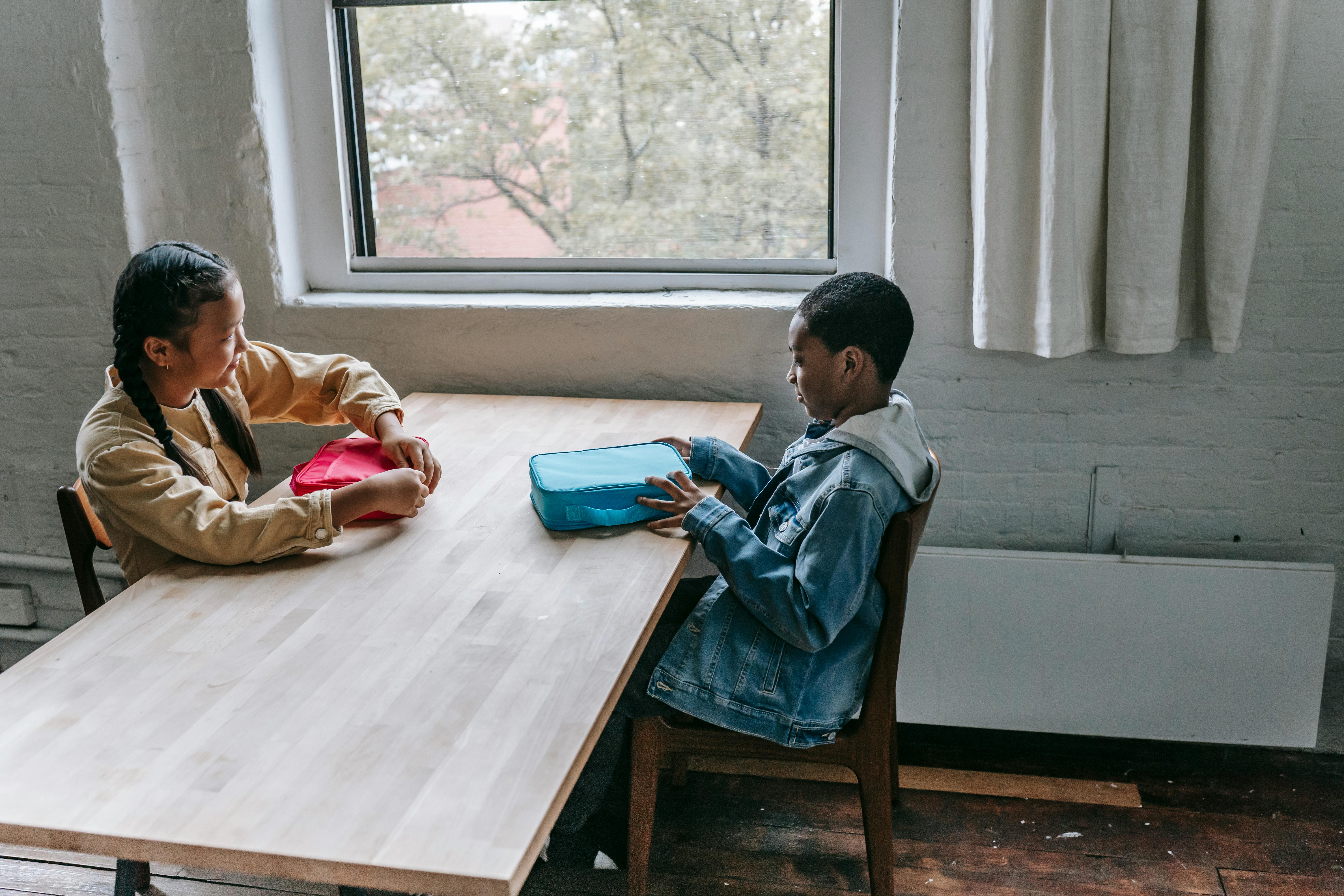 multiracial schoolchildren having breakfast during break