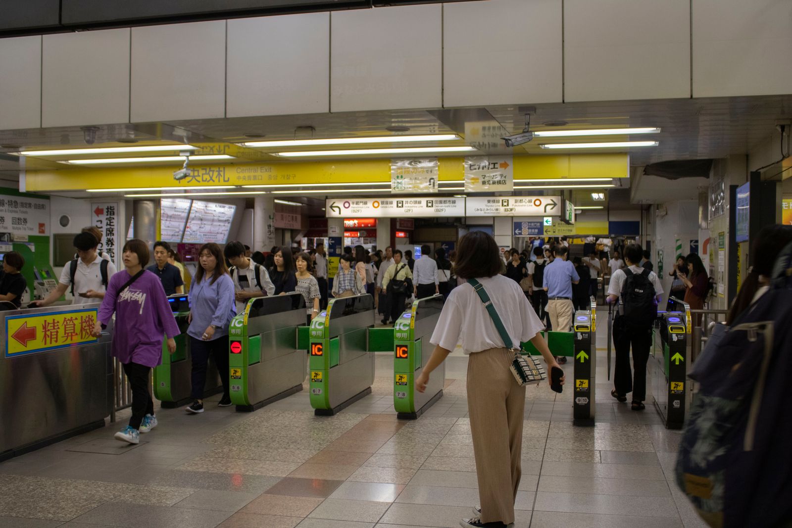 Passengers passing through ticket gates at a Tokyo train station