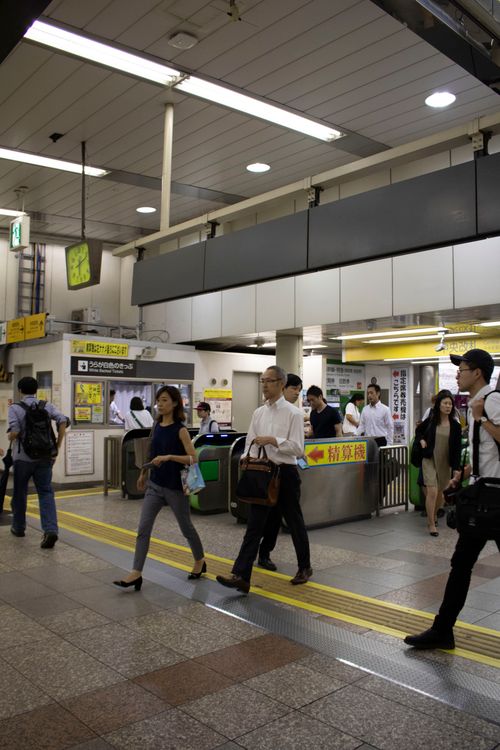 Free People walking in a Tokyo subway station, busy urban commuting scene. Stock Photo