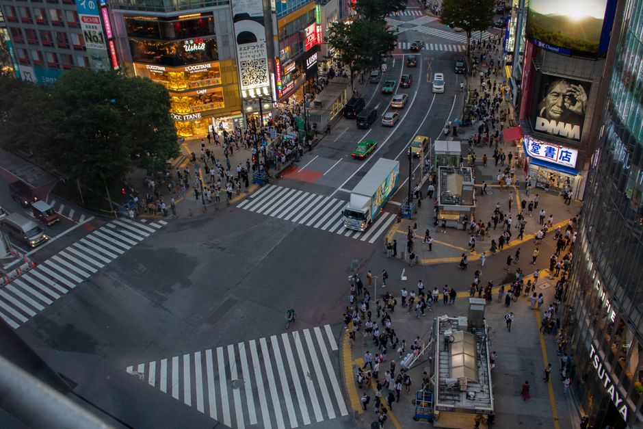 Discover Shibuya Crossing in Tokyo, Japan during twilight, bustling with people and vibrant city lights.