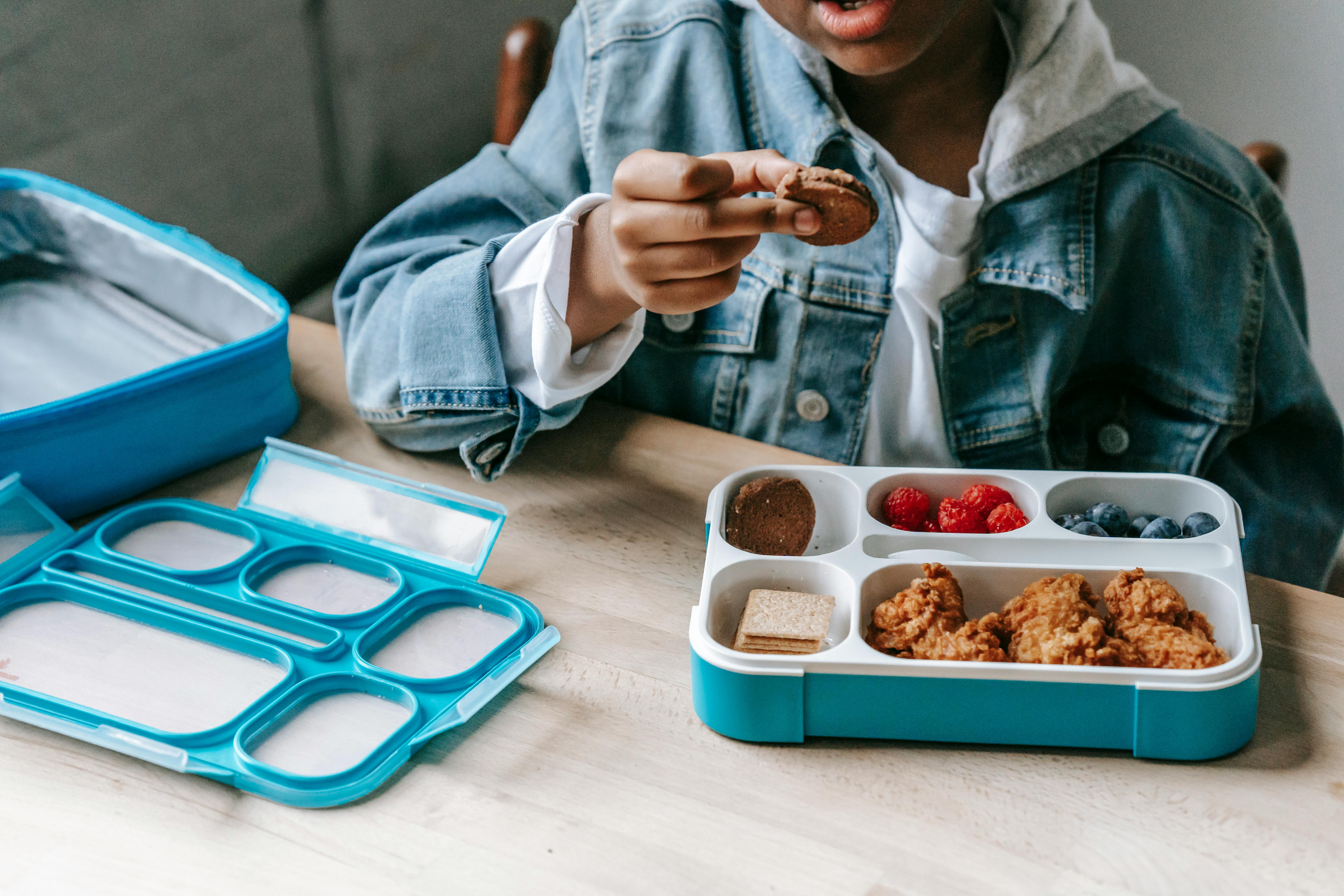 Black boy in denim eating tasty breakfast in plastic container \u00b7 Free ...