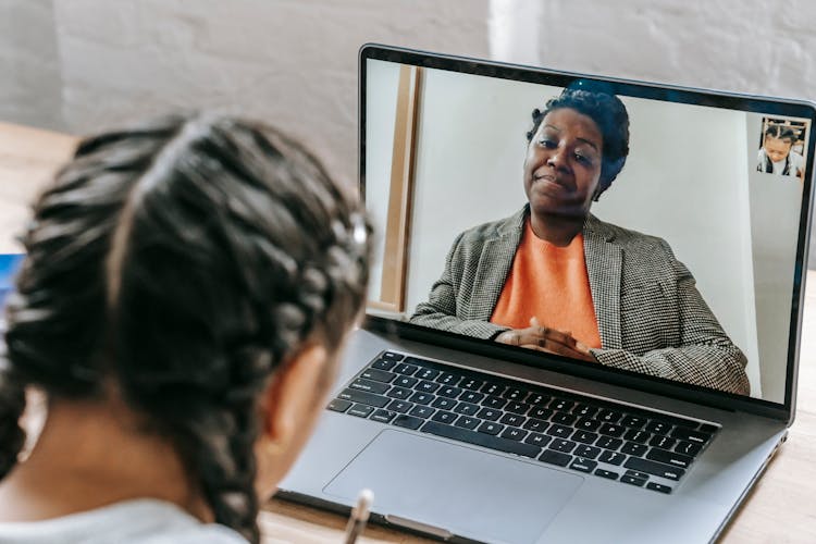 Ethnic Girl Using Laptop While Learning Lesson Online With Teacher