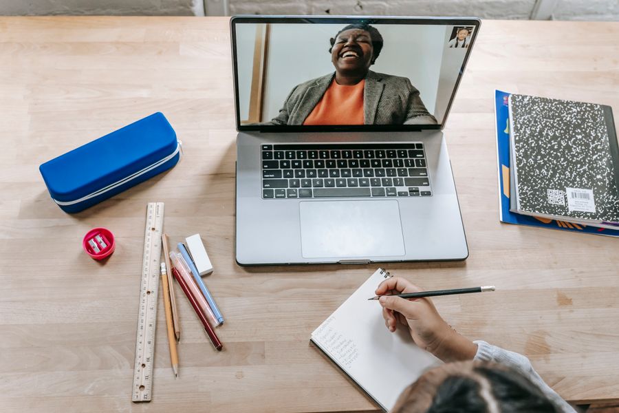 Learner taking notes while completing online professional education