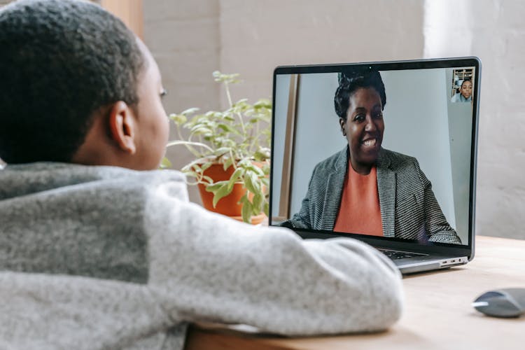 Black Boy Talking With Teacher About School Online