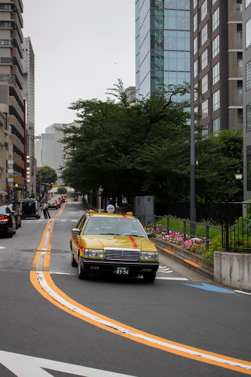 Free Yellow Car on Driving Down the Street Stock Photo