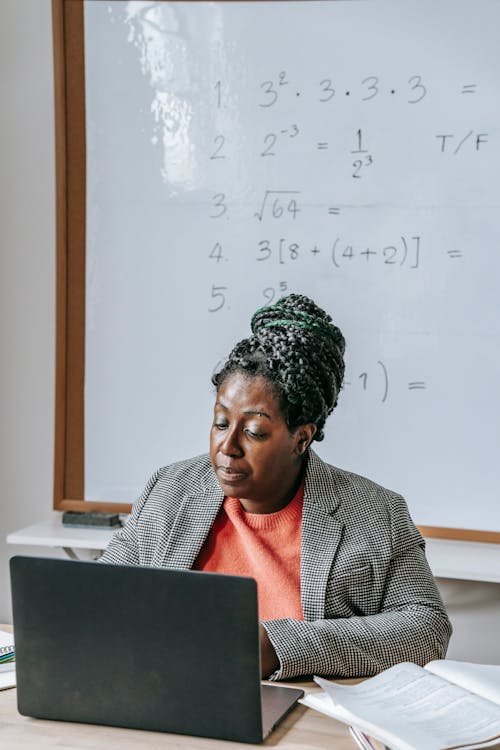Clever black teacher speaking about mathematics online · Free Stock Photo